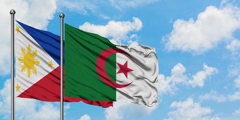 Philippines and Algeria flag waving in the wind against white cloudy blue sky together. Diplomacy concept, international relations.