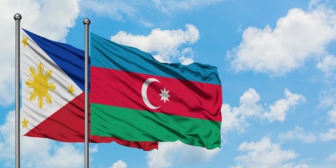Philippines and Azerbaijan flag waving in the wind against white cloudy blue sky together. Diplomacy concept, international relations.