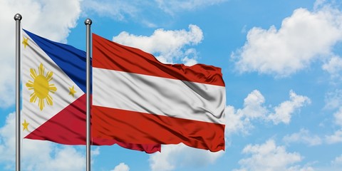 Philippines and Austria flag waving in the wind against white cloudy blue sky together. Diplomacy concept, international relations.