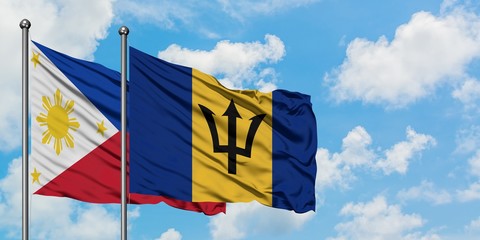 Philippines and Barbados flag waving in the wind against white cloudy blue sky together. Diplomacy concept, international relations.