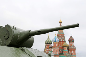 Tank gun on Red square in Moscow on background of St. Basil's Cathedral. Concept for russian...