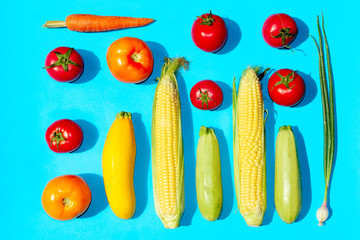 Colorful vegetables over blue background.  Healthy food concept.  Abstract food background.
