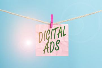 Text sign showing Digital Ads. Business photo showcasing uses the Internet to deliver promotional marketing messages Clothesline clothespin rectangle shaped paper reminder white wood desk