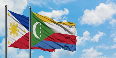 Philippines and Comoros flag waving in the wind against white cloudy blue sky together. Diplomacy concept, international relations.