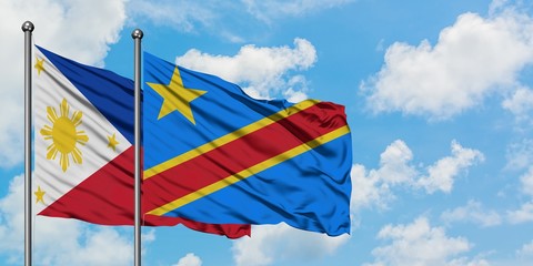 Philippines and Congo flag waving in the wind against white cloudy blue sky together. Diplomacy concept, international relations.