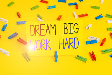 Text sign showing Dream Big Work Hard. Business photo text Believe in yourself and follow the dreams and goals Colored clothespin papers empty reminder yellow floor background office