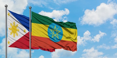 Philippines and Ethiopia flag waving in the wind against white cloudy blue sky together. Diplomacy concept, international relations.
