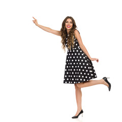 Beautiful Woman Is Standing On One Leg And Trying To Touch Something