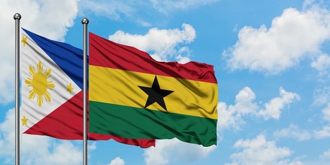 Philippines and Ghana flag waving in the wind against white cloudy blue sky together. Diplomacy concept, international relations.
