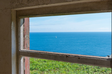 view of the ocean through a ruined house