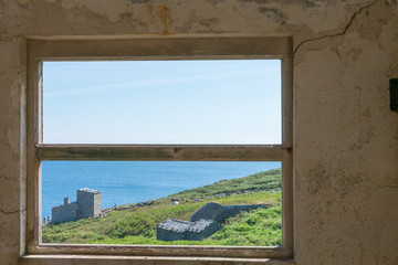 view of the ocean through a ruined house