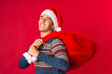 Young man holding a gift on christmas day