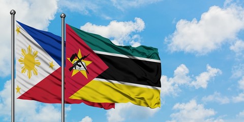 Philippines and Mozambique flag waving in the wind against white cloudy blue sky together. Diplomacy concept, international relations.