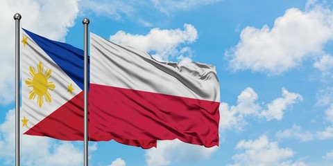 Philippines and Poland flag waving in the wind against white cloudy blue sky together. Diplomacy concept, international relations.