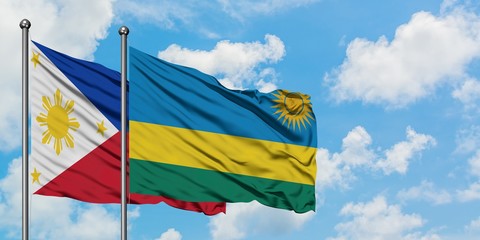 Philippines and Rwanda flag waving in the wind against white cloudy blue sky together. Diplomacy concept, international relations.