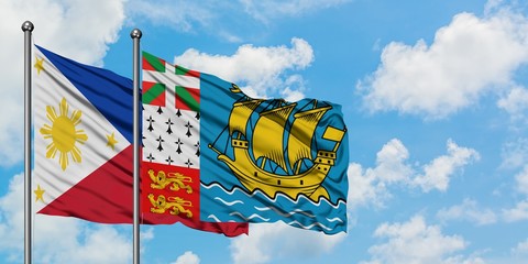 Philippines and Saint Pierre And Miquelon flag waving in the wind against white cloudy blue sky together. Diplomacy concept, international relations.