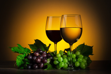 Two glasses of wine and grapes on wooden