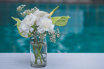 White flowers in vases decorate a table