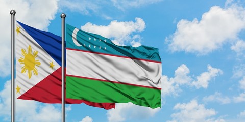 Philippines and Uzbekistan flag waving in the wind against white cloudy blue sky together. Diplomacy concept, international relations.