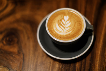 cup of coffee or latte on wooden table