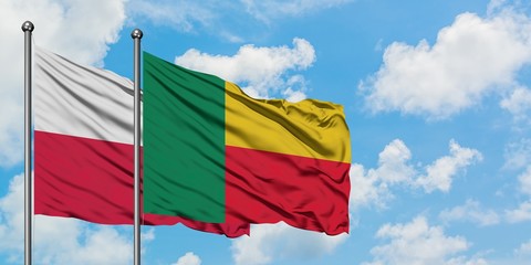 Poland and Benin flag waving in the wind against white cloudy blue sky together. Diplomacy concept, international relations.