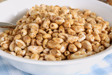 Honey coated puffed wheat breakfast cereal