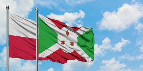 Poland and Burundi flag waving in the wind against white cloudy blue sky together. Diplomacy concept, international relations.