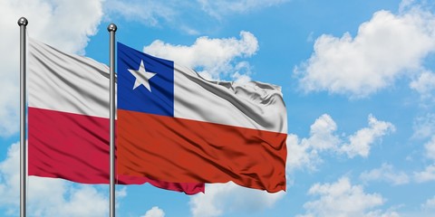 Poland and Chile flag waving in the wind against white cloudy blue sky together. Diplomacy concept, international relations.