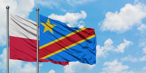 Poland and Congo flag waving in the wind against white cloudy blue sky together. Diplomacy concept, international relations.