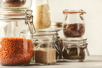 Stocks or set of cereals, pasta, groats, organic legumes and useful seeds in glass jars. Vegan...
