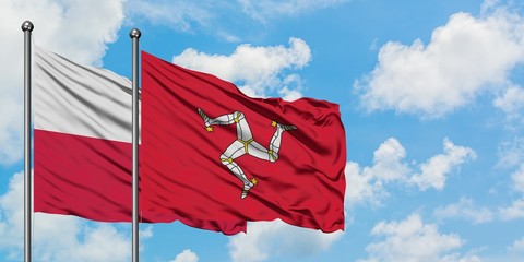 Poland and Isle Of Man flag waving in the wind against white cloudy blue sky together. Diplomacy concept, international relations.