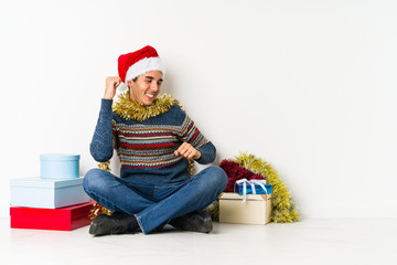 Young man on christmas day shouting excited to front.