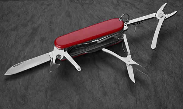 Old Swiss Knife On A Stone Background. Top View