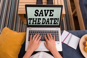 Fototapeta premium Conceptual hand writing showing Save The Date. Concept meaning reserve the mentioned future wedding date on their calendar woman with laptop smartphone and office supplies technology