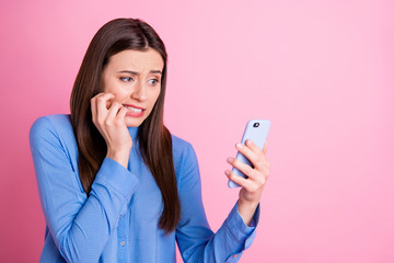 Turned photo of disappointed sad upset student seeing results of exams on her phone holding with...