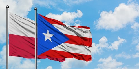 Poland and Puerto Rico flag waving in the wind against white cloudy blue sky together. Diplomacy concept, international relations.