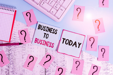 Conceptual hand writing showing Business To Business. Concept meaning Commercial Transaction between two Businesses Writing tools and scribbled paper on top of the wooden table