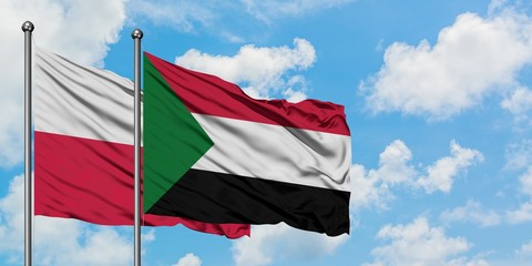 Poland and Sudan flag waving in the wind against white cloudy blue sky together. Diplomacy concept, international relations.