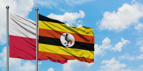 Poland and Uganda flag waving in the wind against white cloudy blue sky together. Diplomacy concept, international relations.