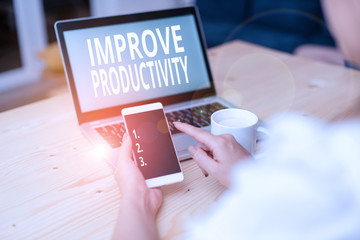 Text sign showing Improve Productivity. Business photo text to increase the machine and process efficiency woman laptop computer smartphone mug office supplies technological devices
