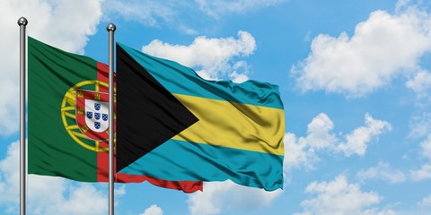 Portugal and Bahamas flag waving in the wind against white cloudy blue sky together. Diplomacy concept, international relations.