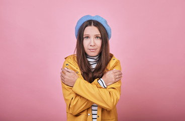 Charming pretty girl with green eyes is frozen and trembling