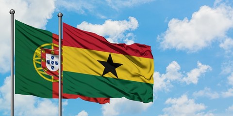 Portugal and Ghana flag waving in the wind against white cloudy blue sky together. Diplomacy concept, international relations.