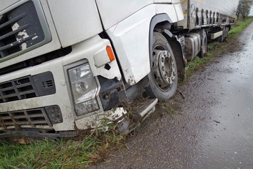 Real event. Car accident. The truck lies in a ditch after the road accident over raining day in...