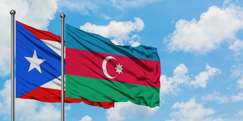 Puerto Rico and Azerbaijan flag waving in the wind against white cloudy blue sky together. Diplomacy concept, international relations.