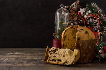 Christmas chocolate panettone cake with christmas decorated on wooden table. Copy space	