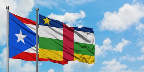 Puerto Rico and Central African Republic flag waving in the wind against white cloudy blue sky together. Diplomacy concept, international relations.
