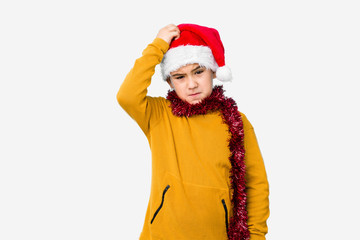 Little boy celebrating christmas day wearing a santa hat isolated being shocked, she has remembered important meeting.