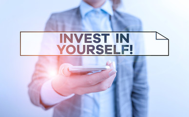 Handwriting text Invest In Yourself. Conceptual photo learn new things or materials thus making your lot better Business concept with mobile phone and business woman