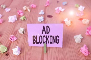Writing note showing Ad Blocking. Business concept for program that will remove different kinds of advertising from web Colored crumpled papers wooden floor background clothespin